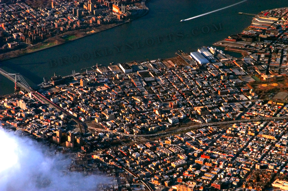 an aerial photo of williamsburg brooklyn showing the williamsburg bridge the south side and the north side